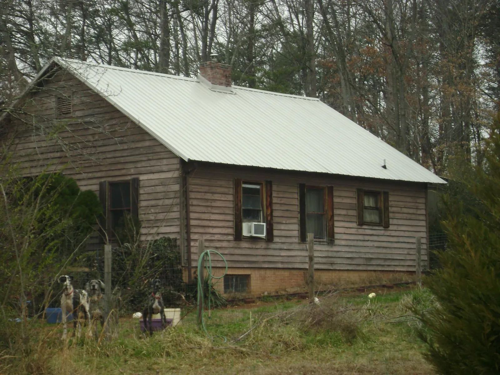 White metal roof on an old wood sided farmhouse, from a Metal Roof Installation job in North Vernon
